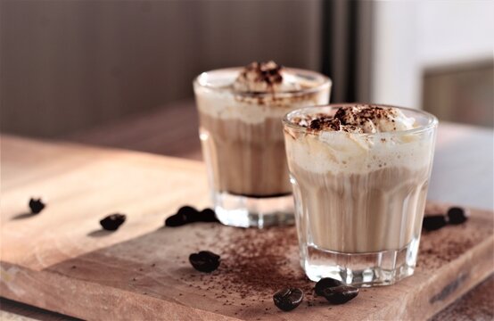 coffee latte with whipped cream and coffee beans