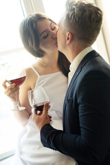newlyweds in love hug, kiss and drink wine, happiness and anticipation of a happy life