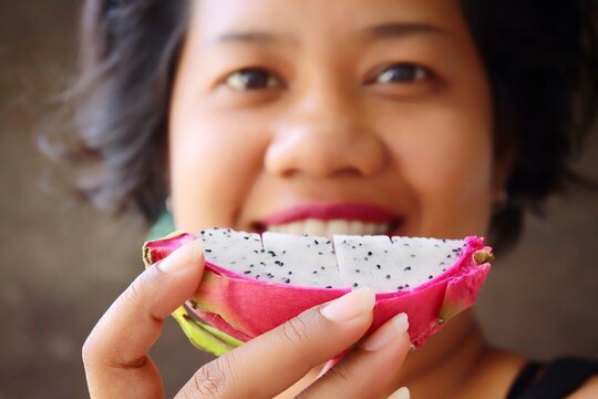 Portrait Of Asia Woman Eating Dragon Tropic Health Fruit