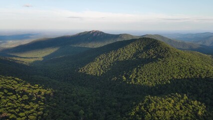 Scenic aerial overview of Shenandoah mountains and hills from above during sunset