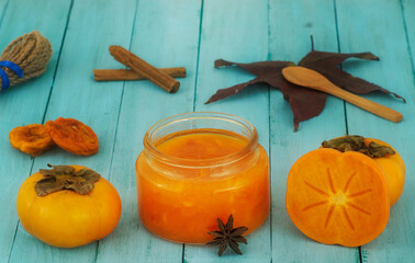 Persimmon jam over a emerald wooden table with some props