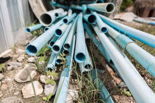 Selective focus of Pile of Many old water  pvc pipes
