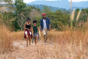 Obraz premium african american family travel together along trekking trail on mountain