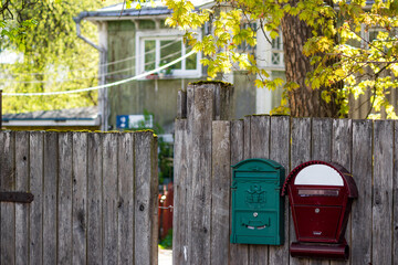 Mailboxes on the fence of a private house in the countryside, a cozy suburban area