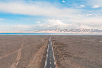 road in the desert heading to the lake