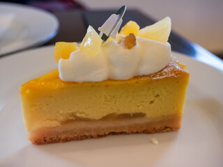 closeup Japanese sweet potato cake topped with cream on table, potato cheese pie