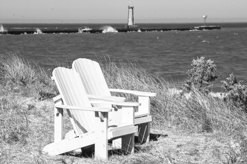 Empty white beach chair along the waterfront