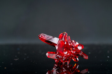 crystal of natural origin. close up of crystals in ruby color on black background