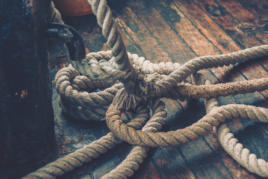 Thick Rope On A Wooden Column Forming A Knot As Part Of The