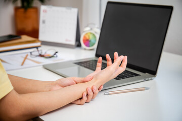 Fototapeta na wymiar Concept office syndrome hand pain from occupational disease, woman having wrist pain from using computer, wrist pain.