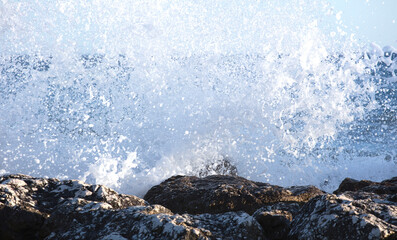 Beautiful waves crashing on the rocks of the bay