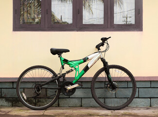 green sporty bicycle made of aluminum with gears used for racing parked in the street 