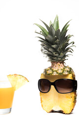 Pineapple half with dark sunglasses and glass on white background for summer holiday funny and vacation concept