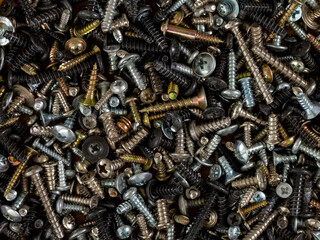Metal fasteners: screws,self-tapping screws,screws,bolts-scattered on the shop window, with various types of accessories for advertising products.