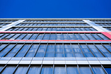 glass facade of a house against a blue sky bottom view