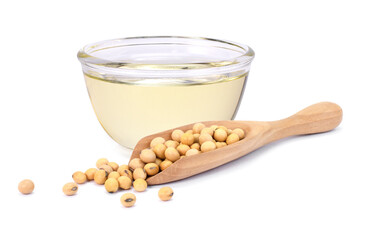Soy bean oil in glass bowl and soybean in wooden spoon isolated on white background. 