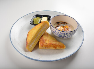 baked layer French cheese egg toast with kaya jam and butter with half boiled egg in bowl western mixed asian halal menu
