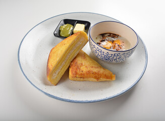 baked layer French cheese egg toast with kaya jam and butter with half boiled egg in bowl western mixed asian halal menu