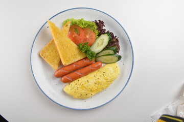 western big breakfast with butter toast, fried scramble egg, sausage, grill bacon, ham, omelette, bean and salad halal breakfast menu 