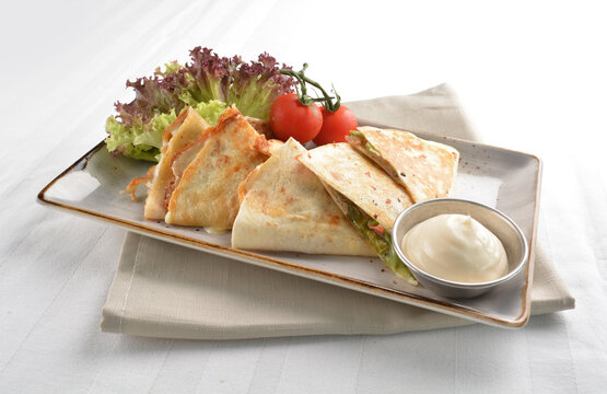 Mexican Pizza Wrapped With Egg, Sausage, Bacon, Ham And Salad Dressing In White Background Halal Breakfast Menu