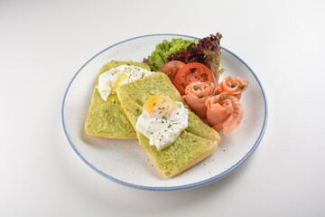 western luxury breakfast with avocado toast, boiled egg, smoked salmon fish, fried potato cake and salad halal breakfast menu 