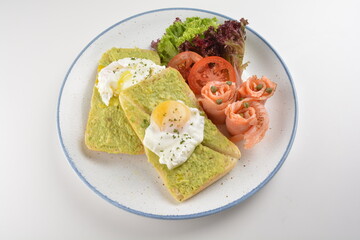 western luxury breakfast with avocado toast, boiled egg, smoked salmon fish, fried potato cake and salad halal breakfast menu 
