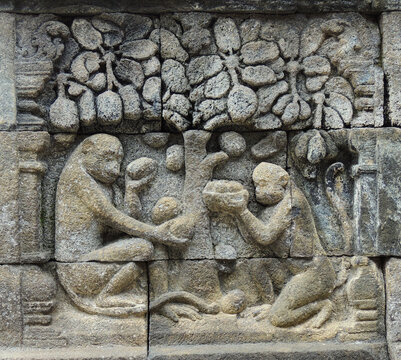 bas-relief panel depicting monkeys in the ninth century mahayana buddhist temple of borobodur,  in magelang, java, indonesia      