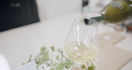 close up person pouring white wine from bottle into wine glass on the table, Holidays Vacation Leisure Drinking Wine beverage drink Food	

