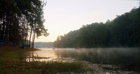 beautiful landscape view of nature sunrise in the morning and bamboo raft while floating on the...