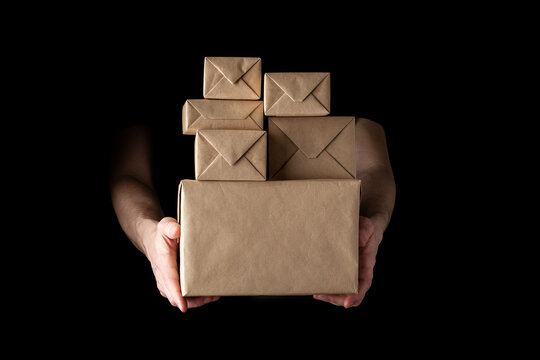 handing over parcels in wrapping paper isolated on black background