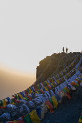 mountain peak with tibetan flags hanging on the rocks in uttarakhand