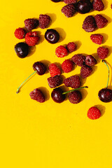 cherry raspberry berries Summer yellow background