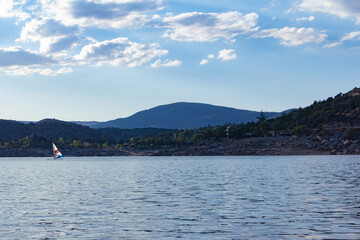 Mountain landscape with a lake a sailing boat. Sport.
