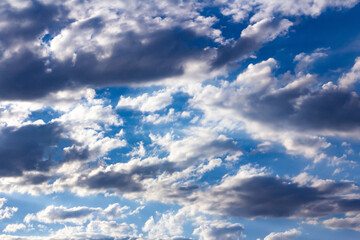 Cumulus clouds in a deep blue sky.