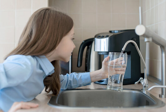 Child open water tap. Kitchen faucet. Glass of clean water. Pouring fresh drink. Hydration. Healthy lifestyle. Water quality check concept. World water monitoring day. Environmental pollution problem
