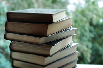 a stack of books in close-up against the background of the street