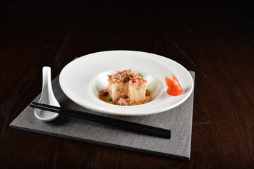 steamed fresh tofu bean curd with Japanese bonito and soy sauce asian in dark background halal menu