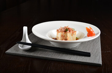 steamed fresh tofu bean curd with Japanese bonito and soy sauce asian in dark background halal menu