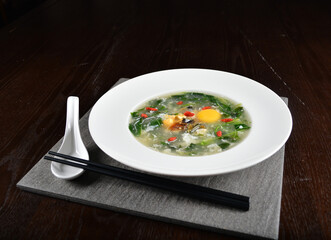 chinese wok fried water spinach vegetable with trio eggs century egg, salted egg, chicken egg and soup in dark background asian halal menu