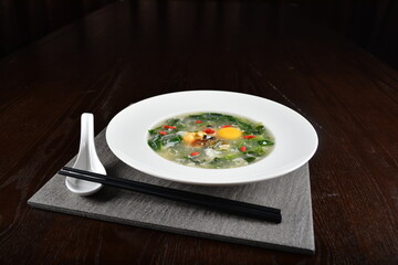 chinese wok fried water spinach vegetable with trio eggs century egg, salted egg, chicken egg and soup in dark background asian halal menu