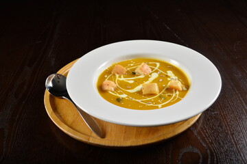 fresh cook golden yellow pumpkin thick soup with bread spread bites and cream appetiser in dark background western halal menu