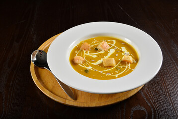 fresh cook golden yellow pumpkin thick soup with bread spread bites and cream appetiser in dark background western halal menu