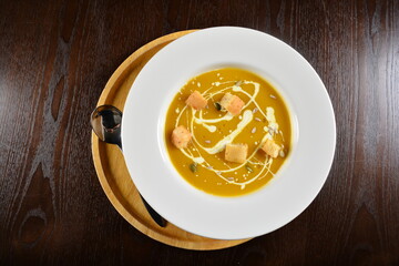 fresh cook golden yellow pumpkin thick soup with bread spread bites and cream appetiser in dark background western halal menu