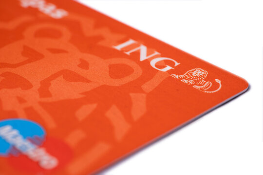 AMSTERDAM, THE NETHERLANDS - AUGUST 14 2020: Orange ING Bank credit and debit card isolated on white. Focus on the words ING