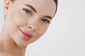 Fototapeta premium Beautiful woman face healthy skin natural make up lips close up blue eyes