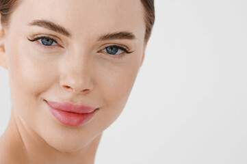 Beautiful woman face healthy skin natural make up lips close up blue eyes