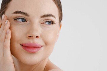 Beautiful woman face healthy skin natural make up lips close up blue eyes