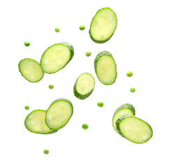 Flying cucumber slices and peas on white background