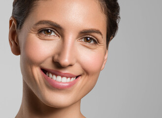 Beautiful healthy teerth smile woman brunette hair natural skin studio portrait