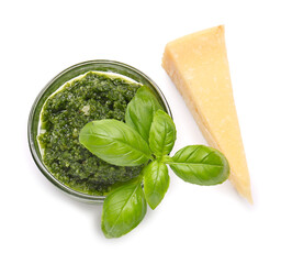 Bowl with fresh pesto sauce, basil leaves and cheese on white background